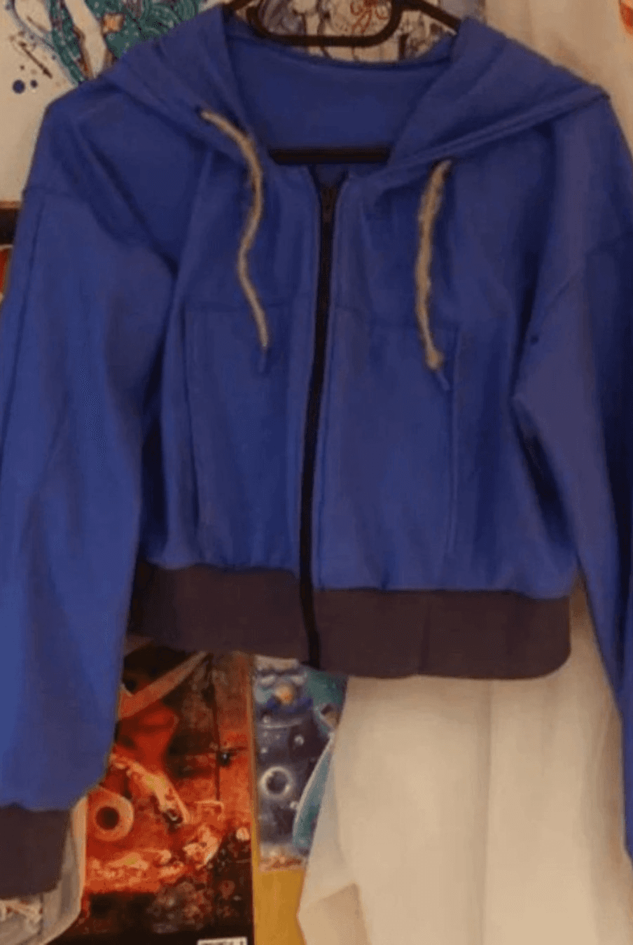 Blue zip-up hoodie with hood and drawstrings, suitable for sewing or crafting projects