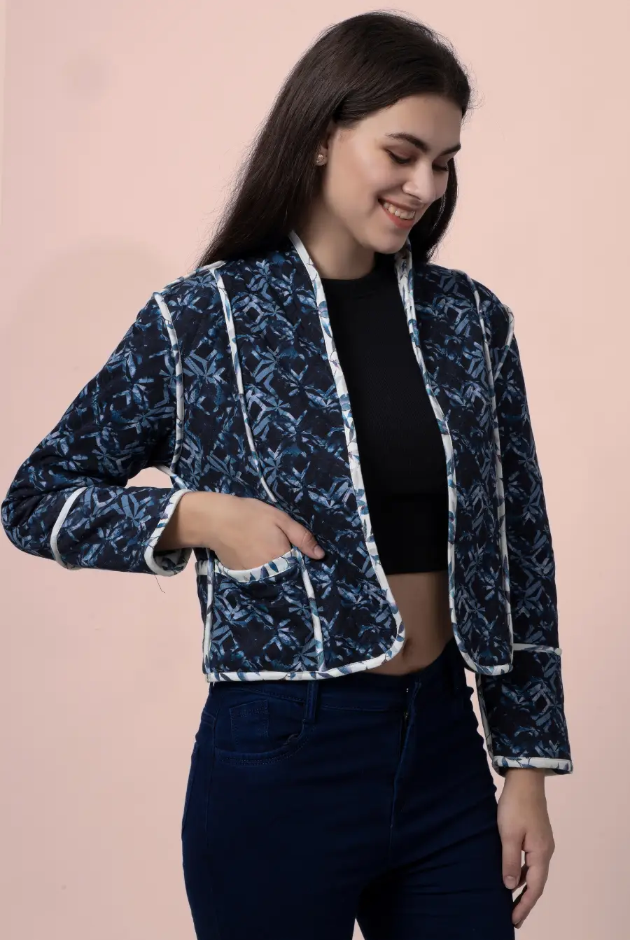 Side view of the Romy reversible quilted jacket in a dark blue geometric pattern. Features contrast binding and a functional pocket for added style.
