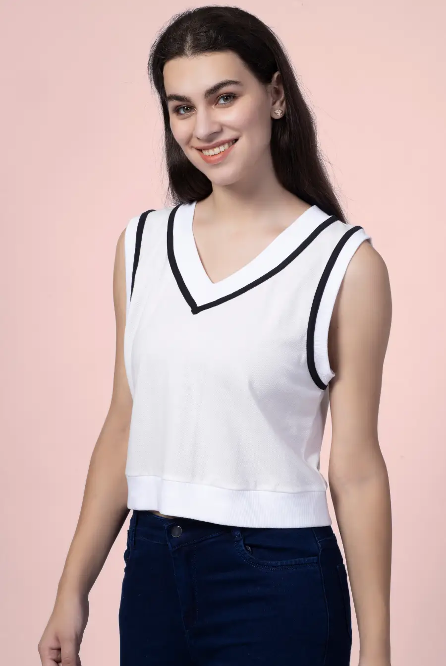 Smiling model wearing the 'Nadine' sweater vest, a chic and comfortable sewing pattern. Ideal for crafting a stylish and sporty wardrobe staple.