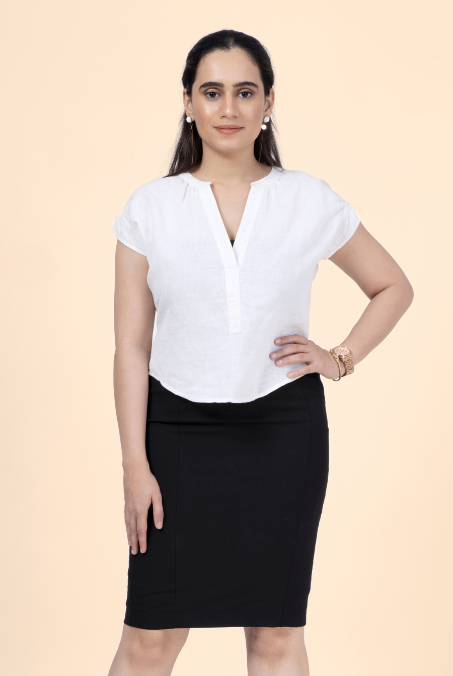 Front view of a model in a white short sleeve blouse from the 'Bliss' sewing pattern. Features a V-neck and relaxed fit, ideal for casual and professional wear.