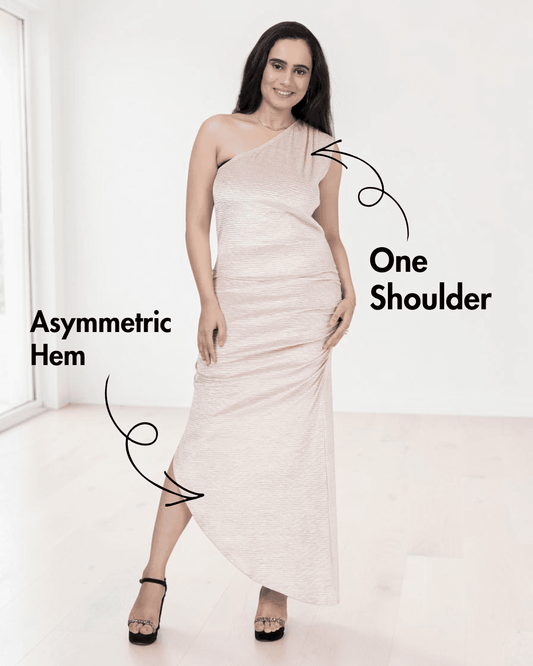 Model wearing one shoulder ruched maxi dress with asymmetric hem, front view