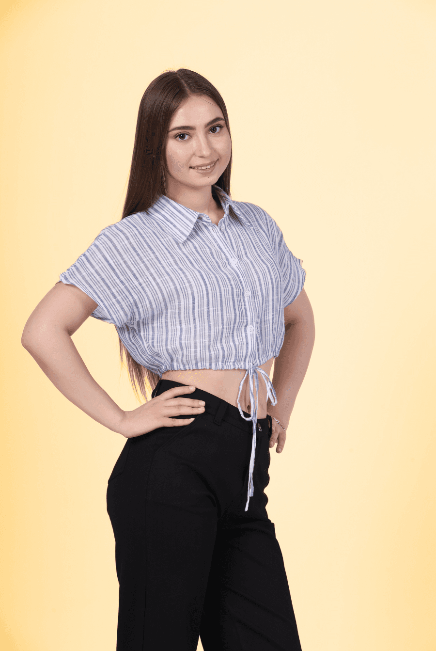 a woman posing for a picture in a shirt and pants designed with winslets patterns