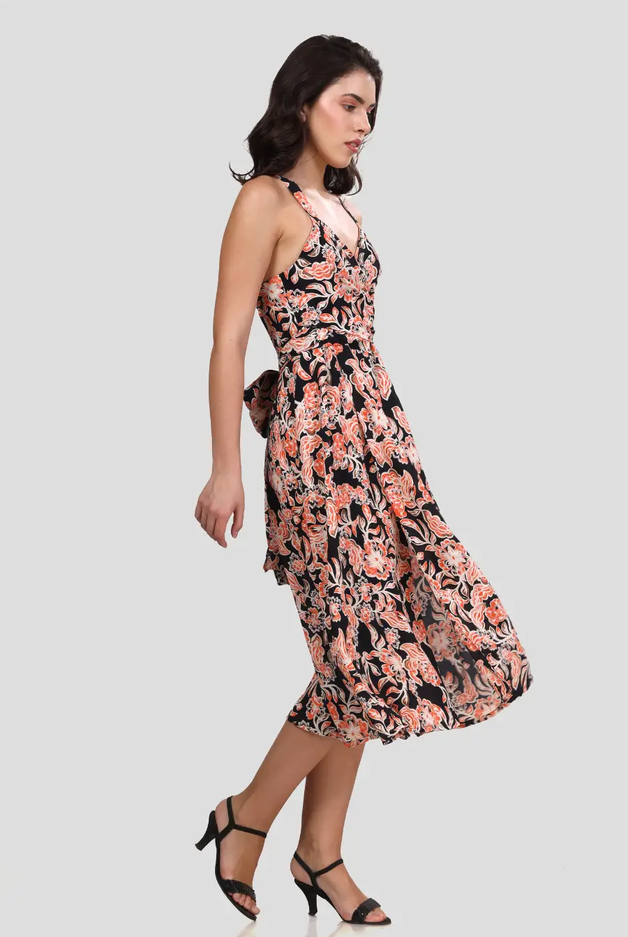 Side angle of the 'Camellia' wrap dress displaying its flattering fit and wrap-around waist tie. The lightweight fabric drapes beautifully.