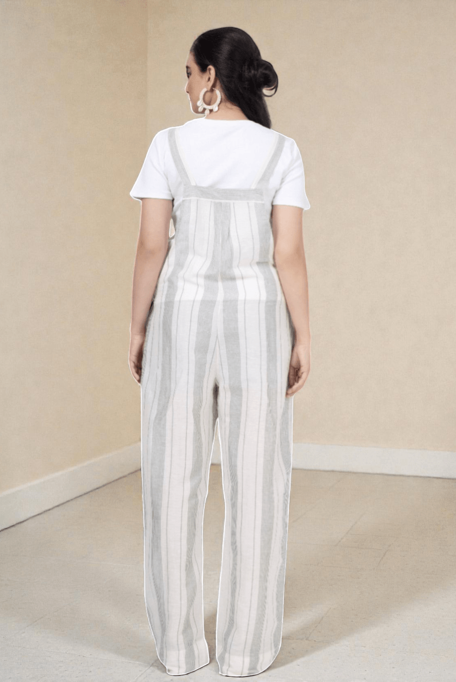 Back view of the 'Belle' overall jumpsuit sewing pattern featuring wide-leg striped pants and adjustable straps, ideal for woven fabrics.