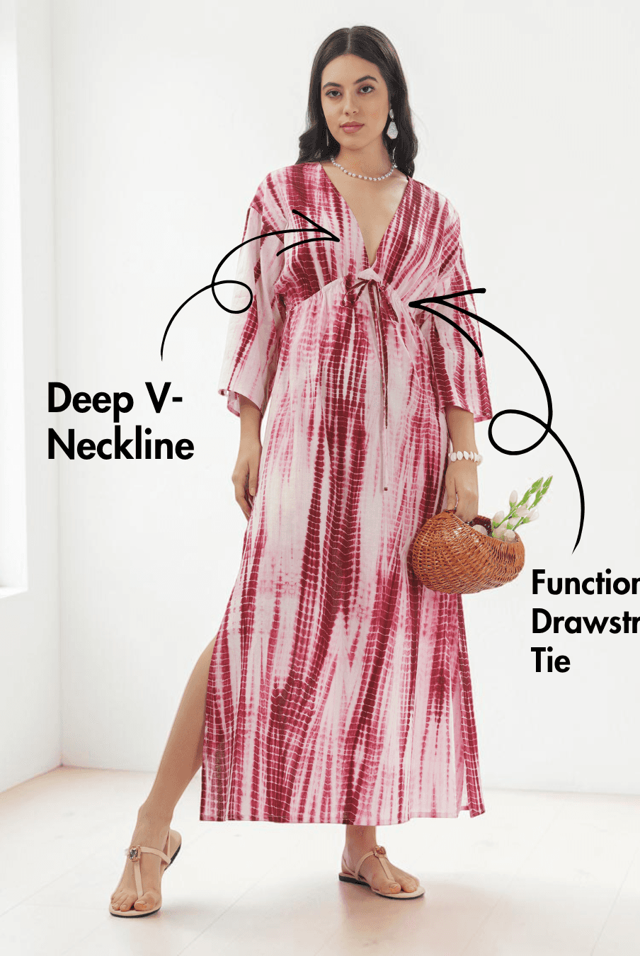 Model wearing pink and red tie-dye kaftan dress with deep V-neckline and wide three-quarter sleeves