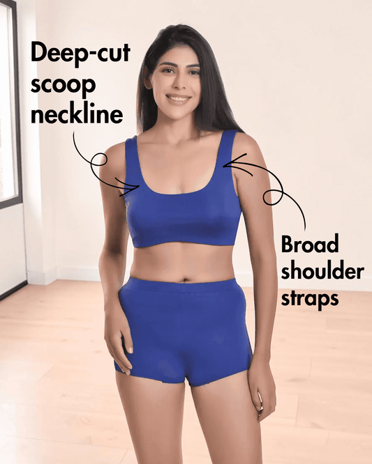 Woman wearing blue sports bikini top with broad shoulder straps and high-waisted shorts