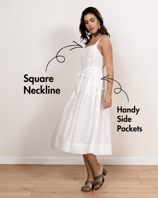 Model wearing white sundress with square neckline, adjustable straps, and side pockets, showcasing the Fiona sewing pattern