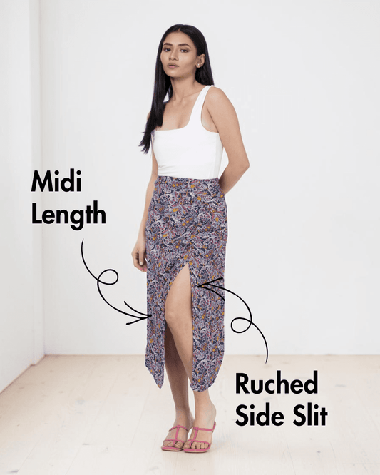 Model wearing midi skirt with side slit and patterned fabric