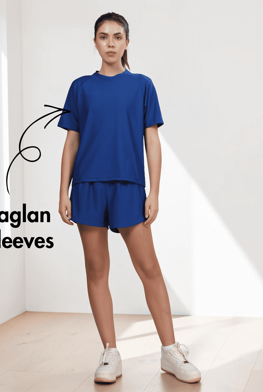 Model wearing blue activewear set with raglan T-shirt and shorts