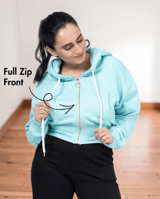 Close-up of woman in light blue zip-up hoodie with full front zipper, highlighting the sewing pattern details for a women's crop jacket