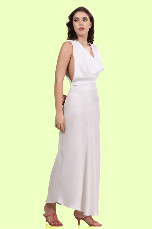 Side view of a model wearing backless cowl neck gown