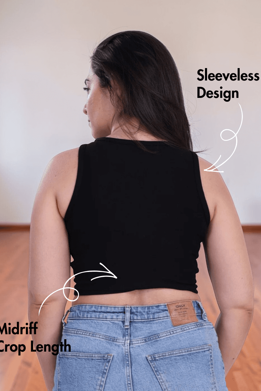 Back view of woman in black sleeveless crop tank top showing sleeveless design and crop length