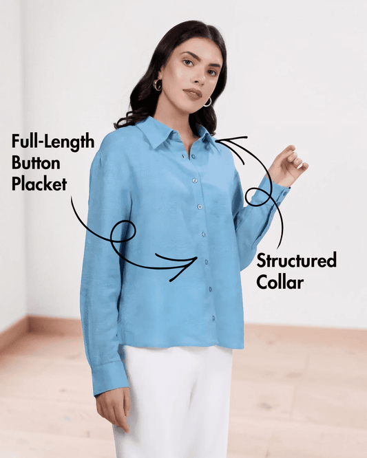 Close-up of blue shirt showing button-down design and collar details
