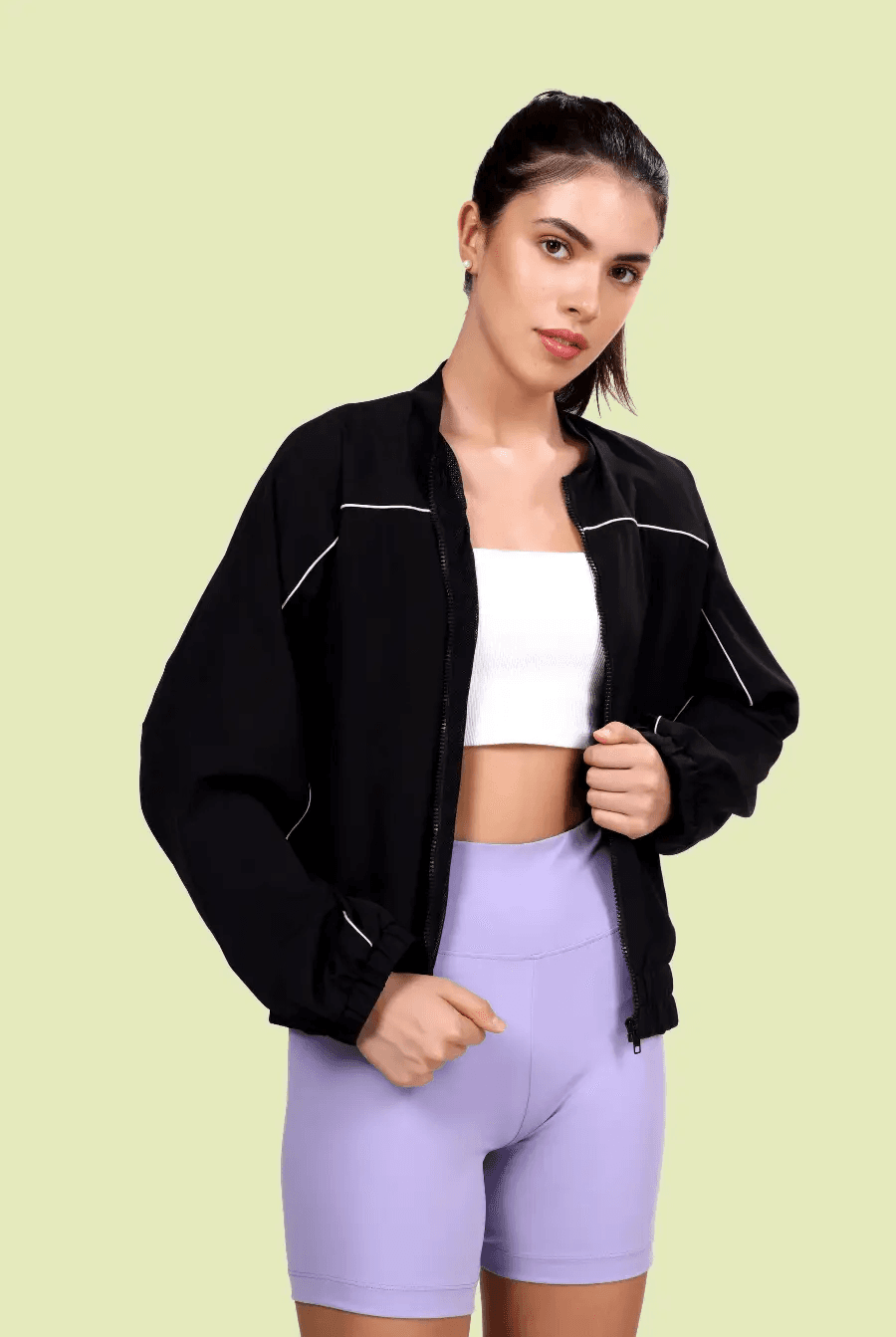 Model wearing the Naomi windbreaker, a lightweight jacket with a relaxed fit, elasticated hem, and subtle piping details. Perfect for breezy weather and seasonal transitions.