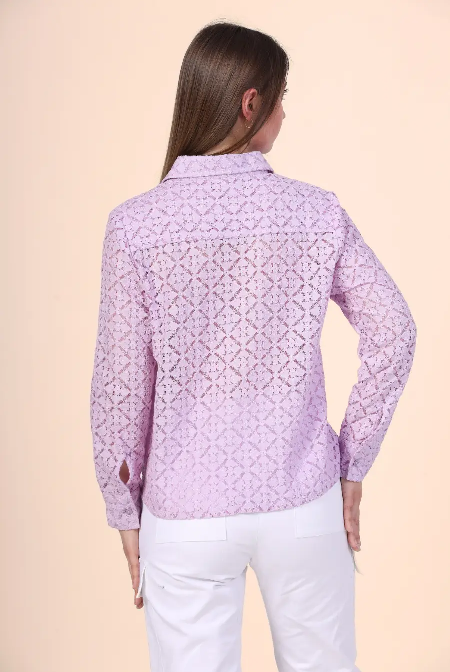 a woman wearing a pink shirt made from winslet's button down shirt sewing pattern and white pants