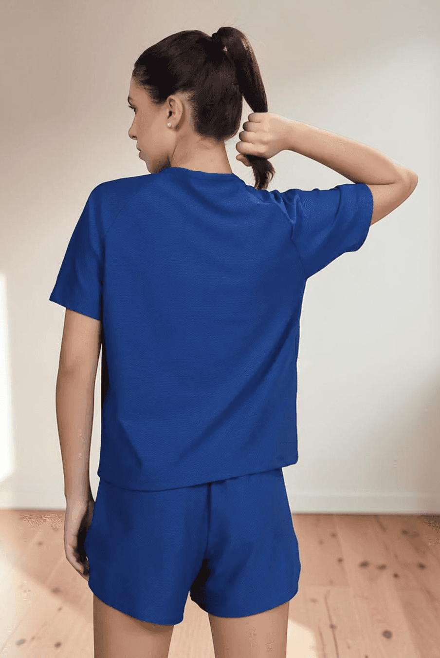 Back view of blue women's casual T-shirt with raglan sleeve design and relaxed fit