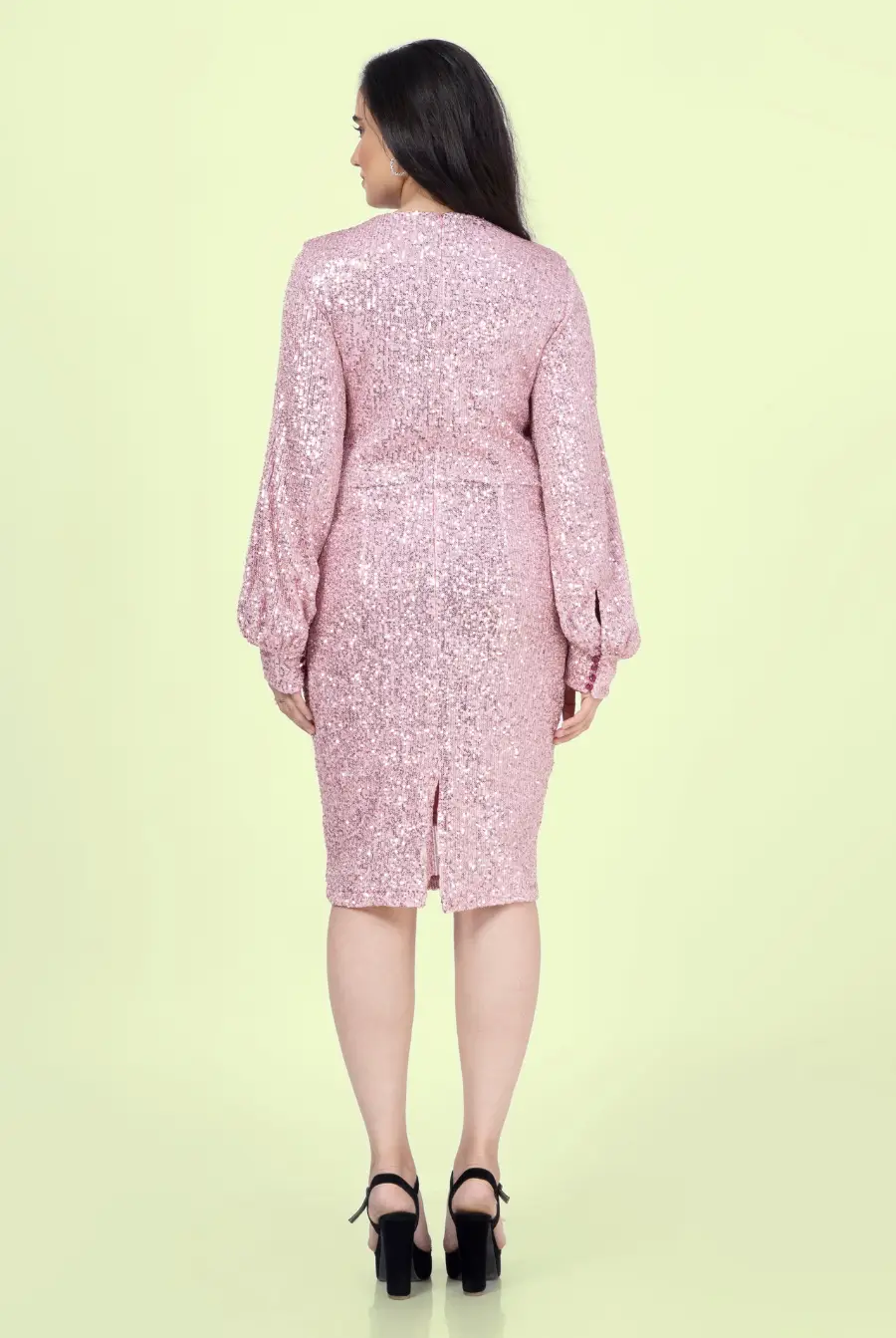 Back view of a model wearing a sheath dress with keyhole
