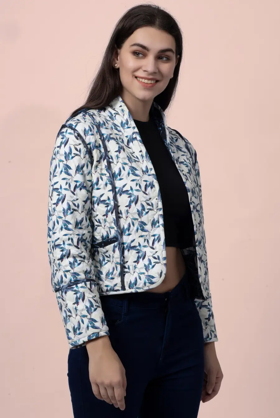 Close-up of the Romy reversible quilted jacket featuring a blue and white leaf pattern. Stylish, lightweight, and structured with contrast binding.