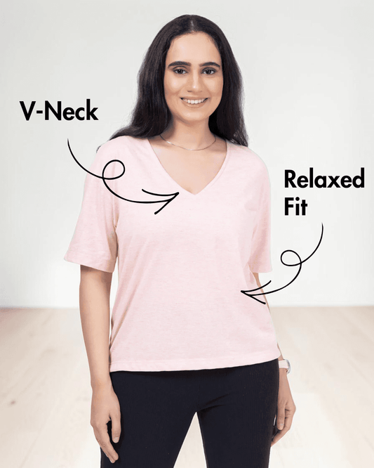 Close-up of woman in pink V-neck T-shirt, showing relaxed fit and short sleeves
