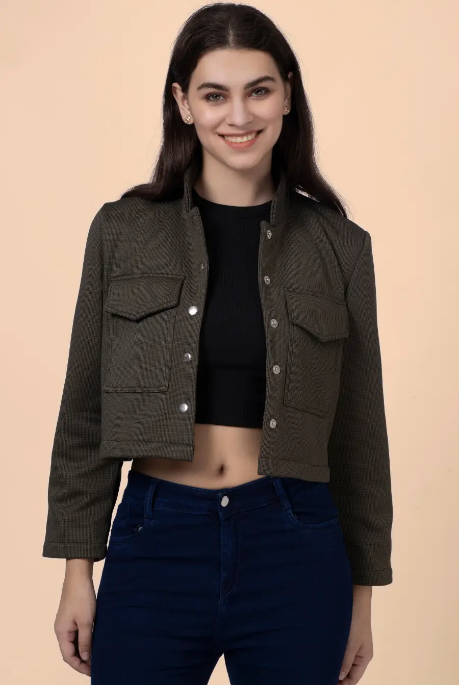 Close-up of the 'Noelle' short jacket, showcasing its structured design, button-front closure, and utilitarian chest pockets.