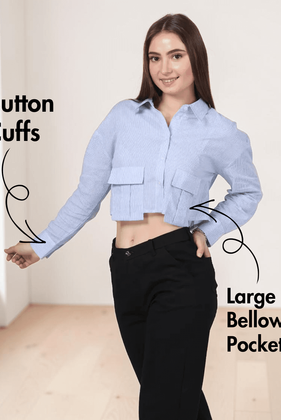 Closeup view of woman in blue striped utility shirt with point collar and long sleeves, paired with black pants