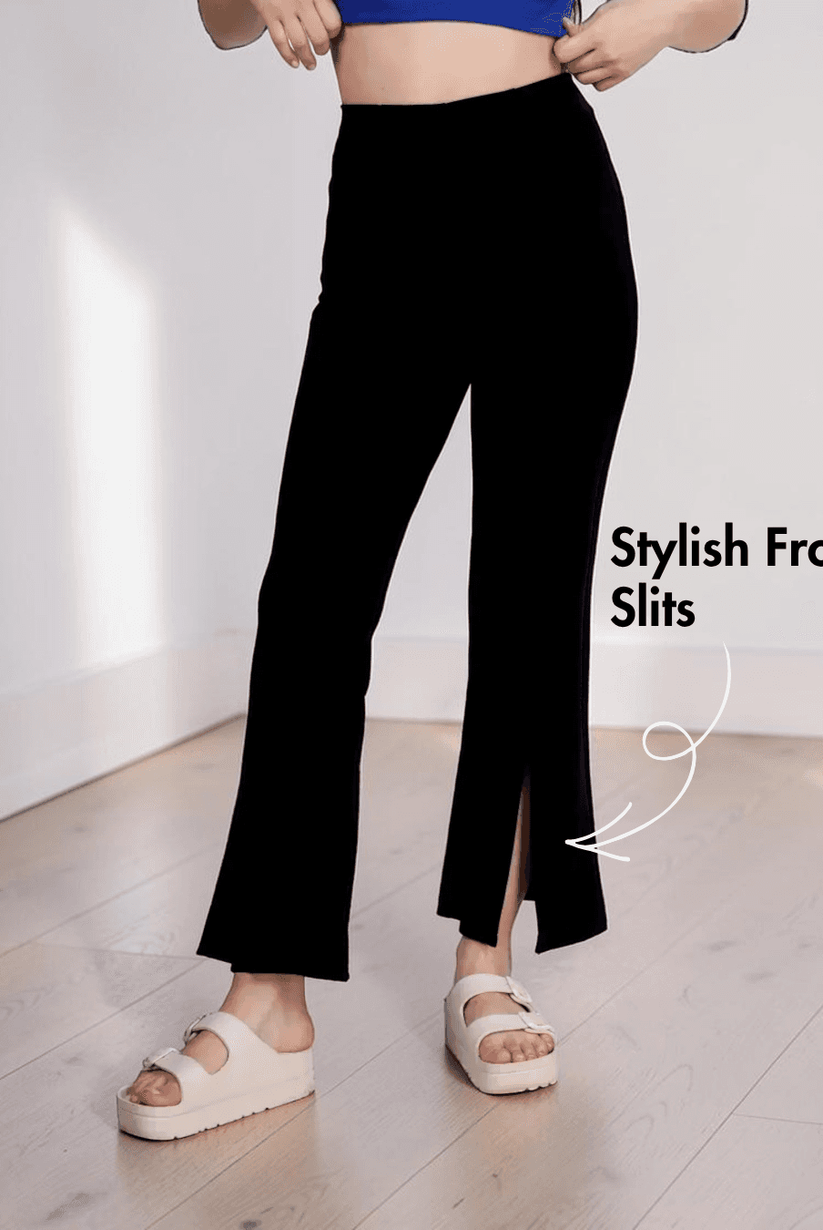 Close-up of black bell bottom pants with stylish front slits and elastic waistband