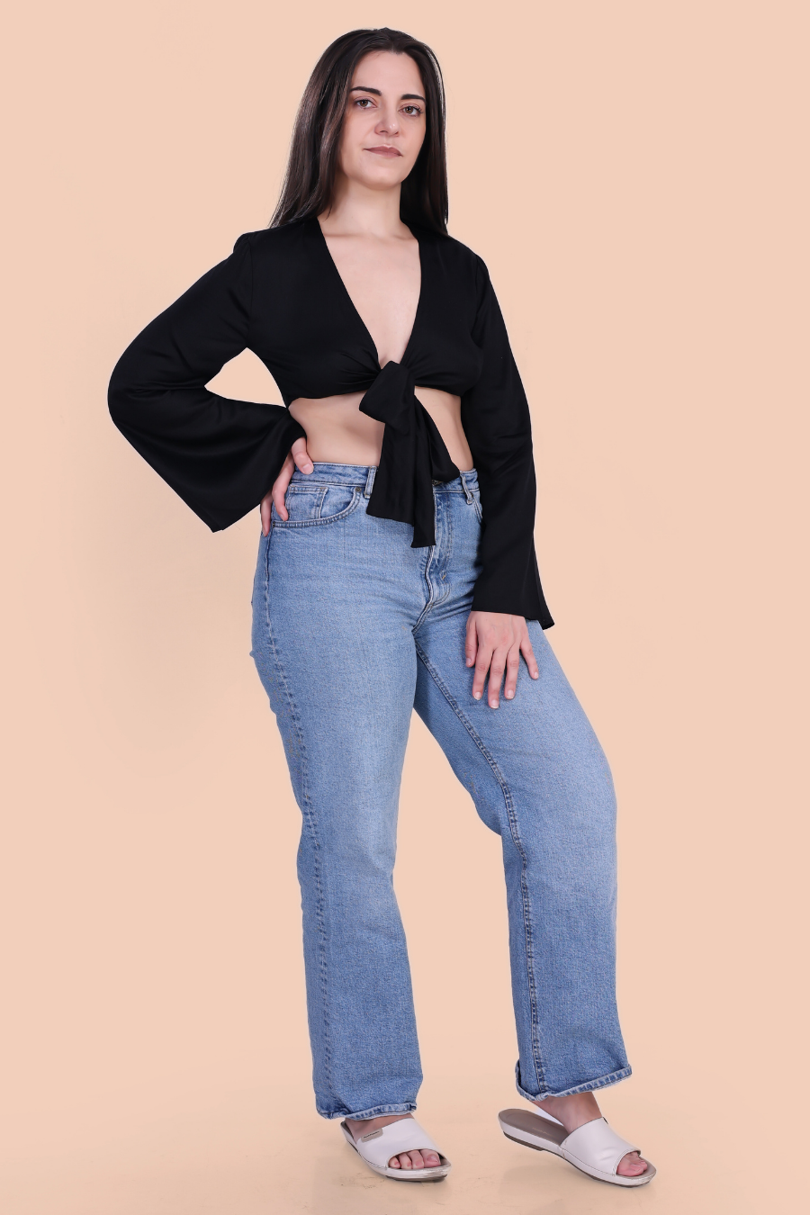 Full Length Image of a model wearing a tie front crop top sewed with winslet's patterns paired with blue jeans