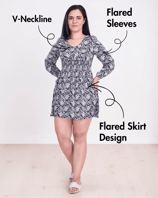 Model wearing a floral shirred dress with flared skirt and puffed sleeves