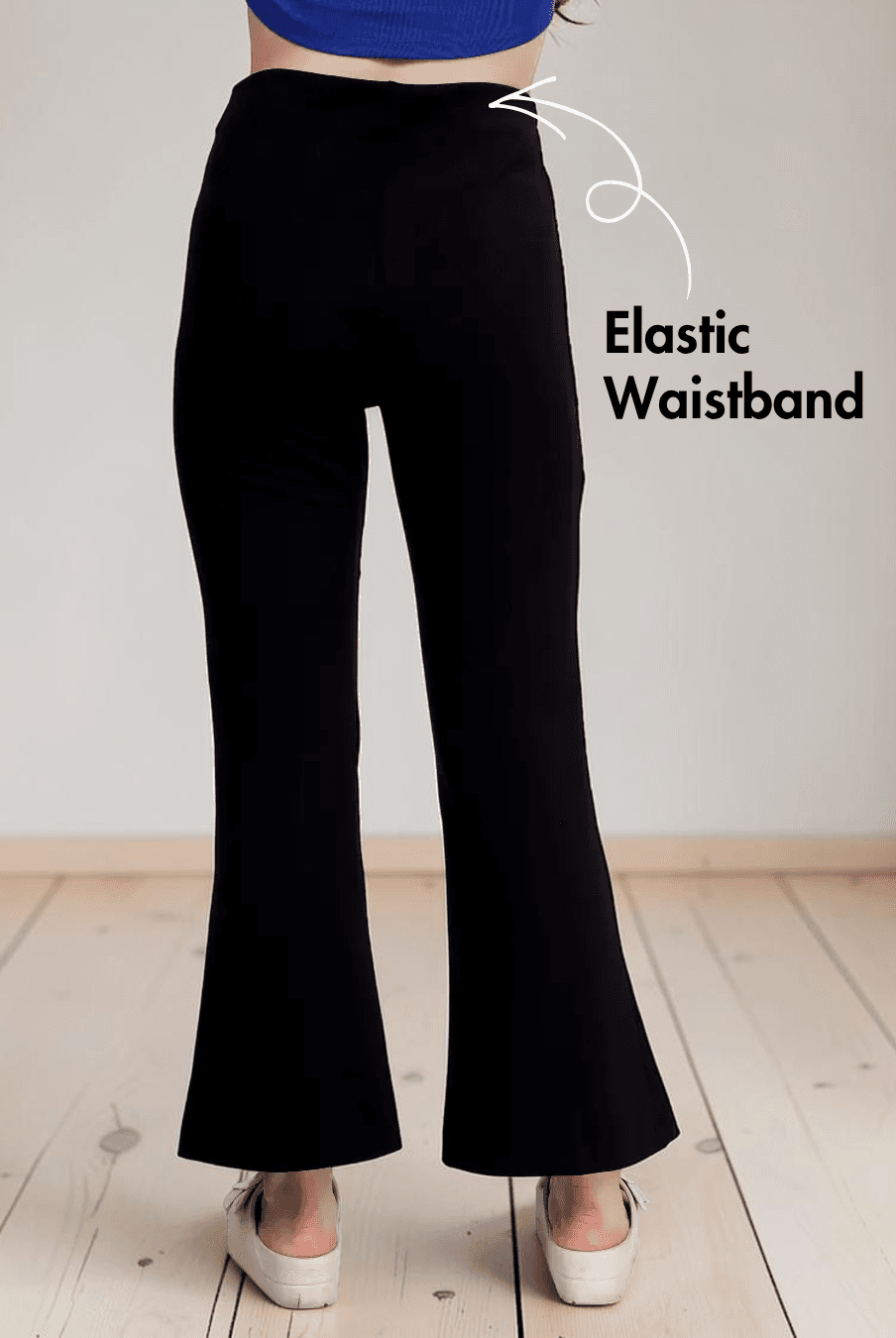 Close-up of black bell bottom pants with stylish front slits and elastic waistband