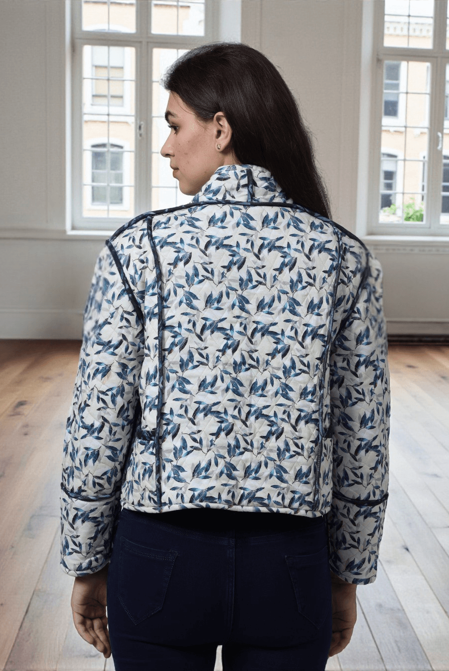 Back view of Romy reversible quilted jacket pattern featuring hip-length cut, long sleeves, and detailed seam binding for a polished handmade finish.