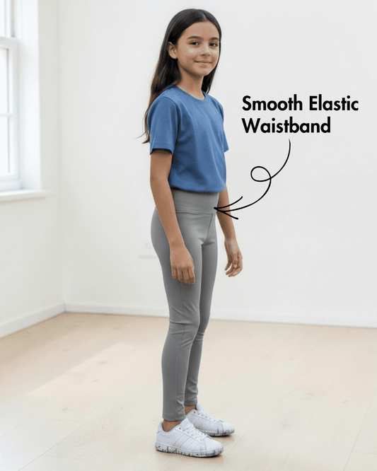 Side view of girl in blue T-shirt and gray leggings with smooth elastic waistband, highlighting Kid's Leggings Sewing Pattern Avery