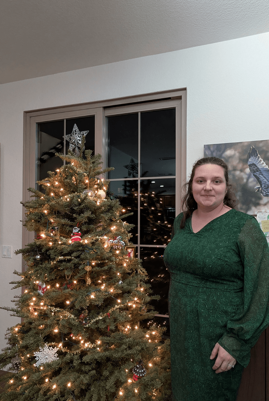 Keyhole Sheath Dress 'Celestia' sewing pattern made in green woven fabric, styled for a festive holiday look with long bishop sleeves.