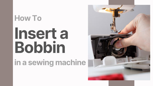 Hand inserting a bobbin into a sewing machine during setup process.