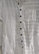 White linen shirt dress with traditional collar, button-down front, and side pockets