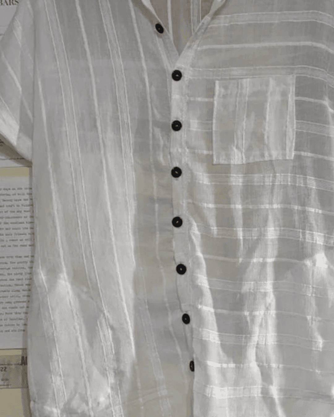 White linen shirt dress with traditional collar, button-down front, and side pockets