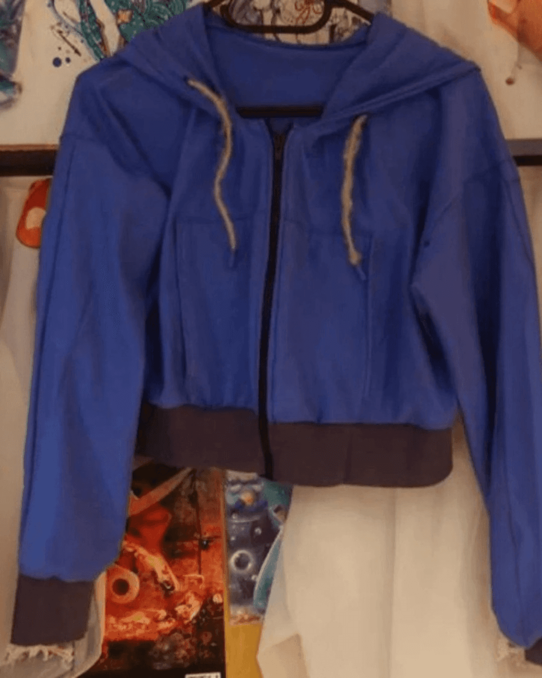 Blue zip-up hoodie with hood and drawstrings, suitable for sewing or crafting projects