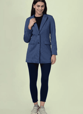 Model showcasing the 'Camille' straight-cut coat sewing pattern. The coat is styled with leggings and sneakers, highlighting its versatile and modern fit.