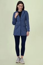 Model showcasing the 'Camille' straight-cut coat sewing pattern. The coat is styled with leggings and sneakers, highlighting its versatile and modern fit.