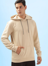 Side view of a beige men's hoodie from the 'Atlas' sewing pattern. Showcases a comfortable fit with a front pocket and ribbed cuffs for a casual look.