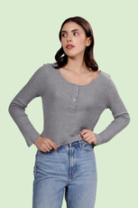 Model wearing a gray long sleeve Henley top made using the Riley sewing pattern. Features a buttoned neckline and a comfortable fit.