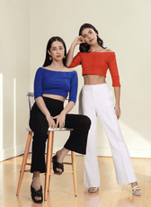 Women wearing off-the-shoulder crop top with three-quarter sleeves, styled for fashion