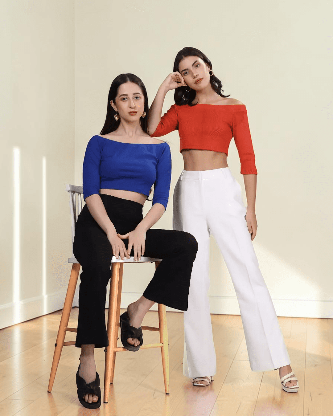 Women wearing off-the-shoulder crop top with three-quarter sleeves, styled for fashion