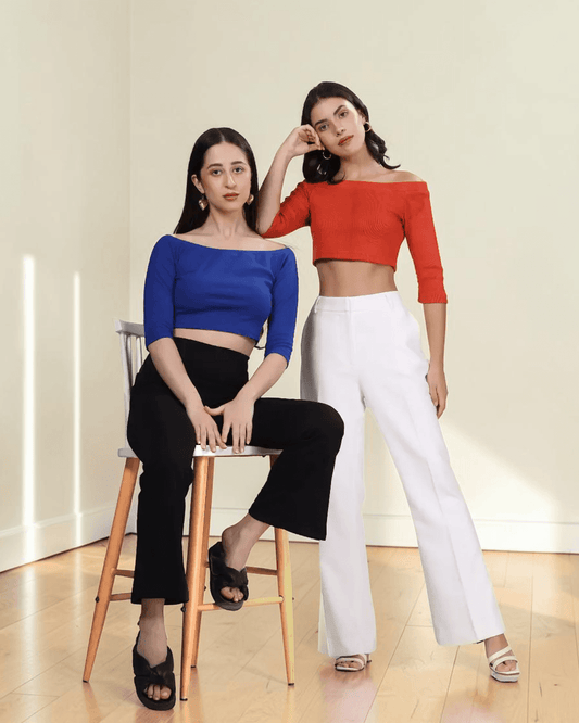 Women wearing off-the-shoulder crop top with three-quarter sleeves, styled for fashion