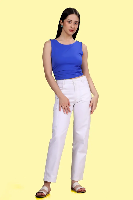 Front view of a model wearing a blue ruched top sewn with Winslet's pattern, showcasing a flattering fit and chic style. Paired with trousers