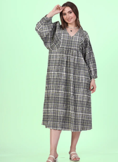 Front view of a model wearing a midi dress, with a comfortable fit sewed with winslet's patterns