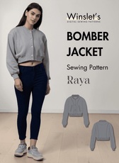 Gray bomber jacket with ribbed cuffs, waistband, round neck, and snap buttons, shown on a model