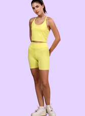 Model wearing high-waisted biker shorts from the 'Nadia' sewing pattern. Perfect for workouts and casual wear, designed for comfort and style.