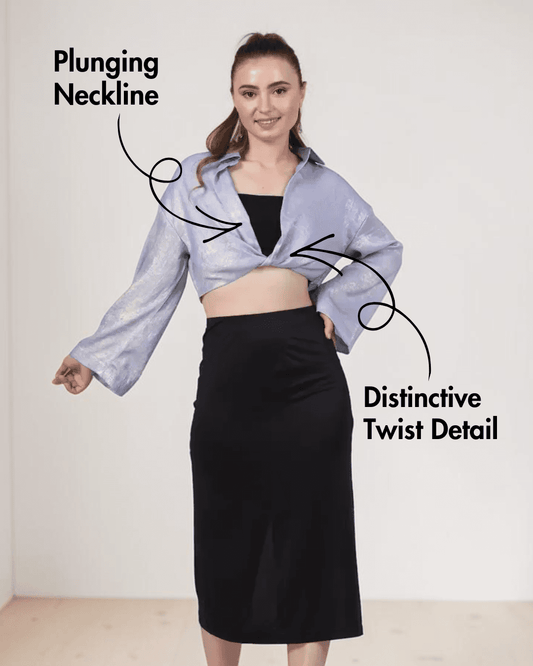 Front view of blue twist front crop shirt with long bell sleeves and distinctive twist detail