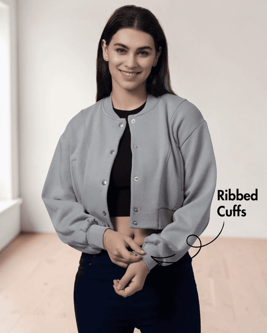 Model wearing a gray bomber jacket with ribbed cuffs, waistband, and front button closure