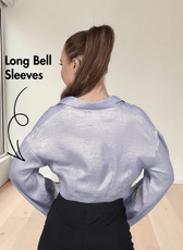 Back view of blue twist front crop shirt with long bell sleeves and distinctive twist detail